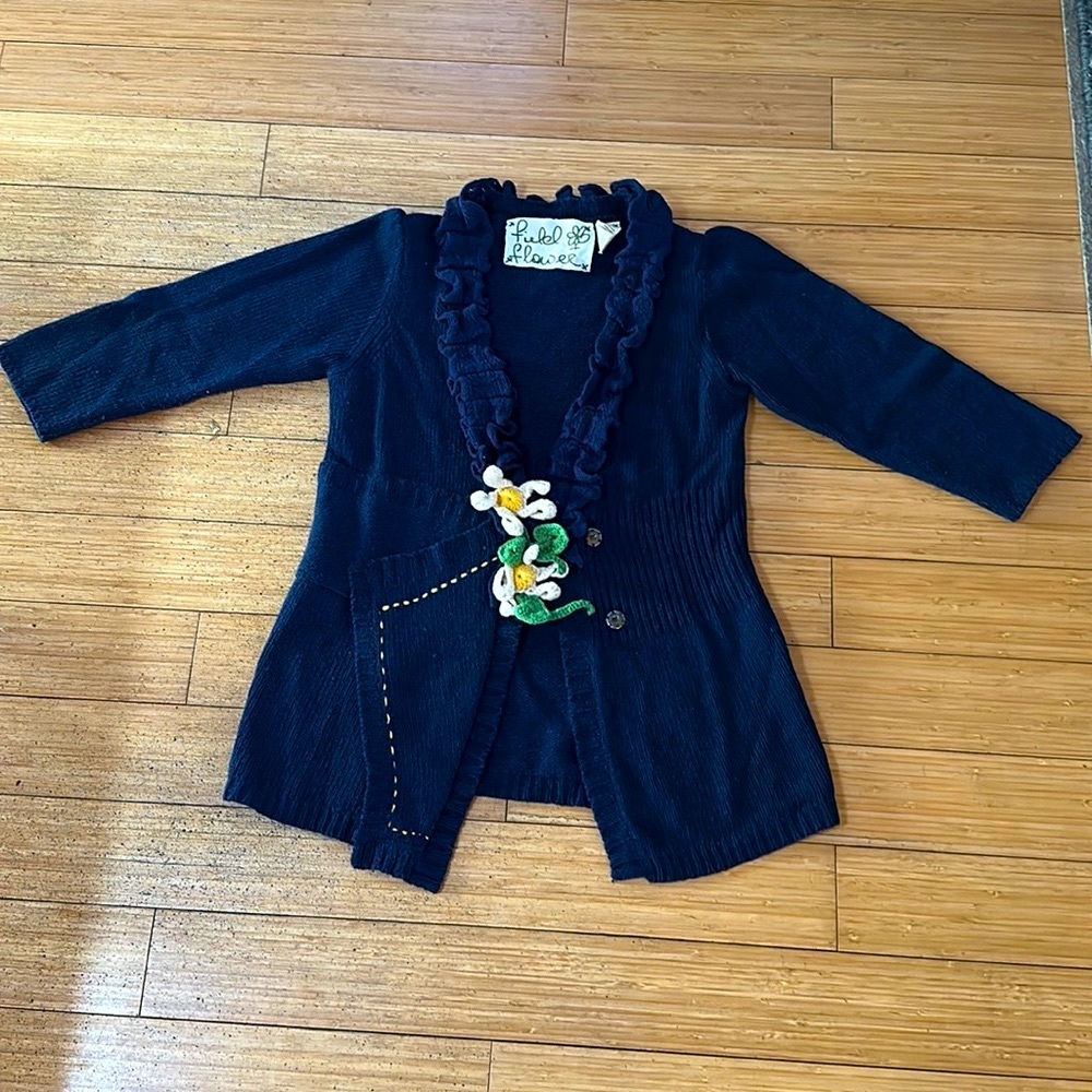 Blue Anthropologie sweater with flower and ruffles size M